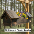 Wooden birdhouse with planter filled with flowers against a forest background